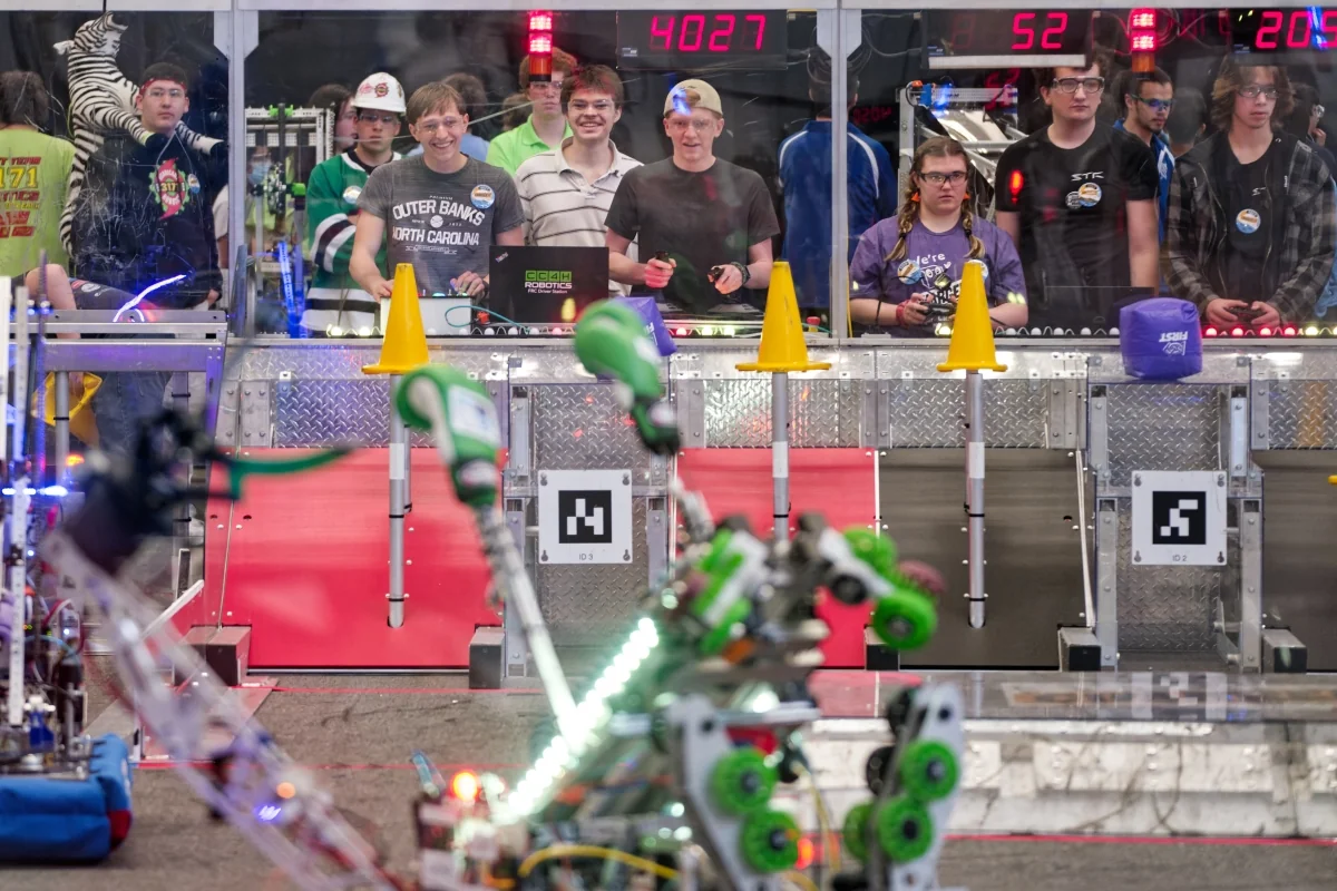 Team members watching a match from the driver station